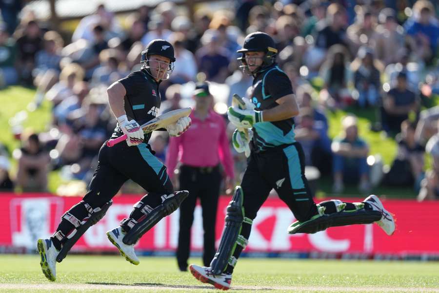 New Zealand's Tim Seifert (L) and Tom Latham run between wickets