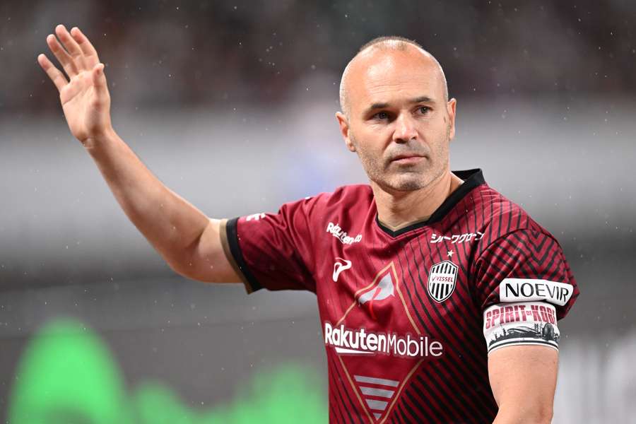 Andres Iniesta waves to supporters at the end of the friendly match between Vissel Kobe and Barcelona