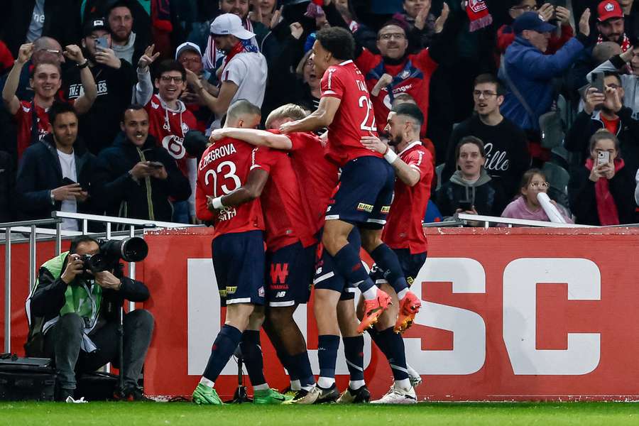 Lille's players celebrate scoring their first goal