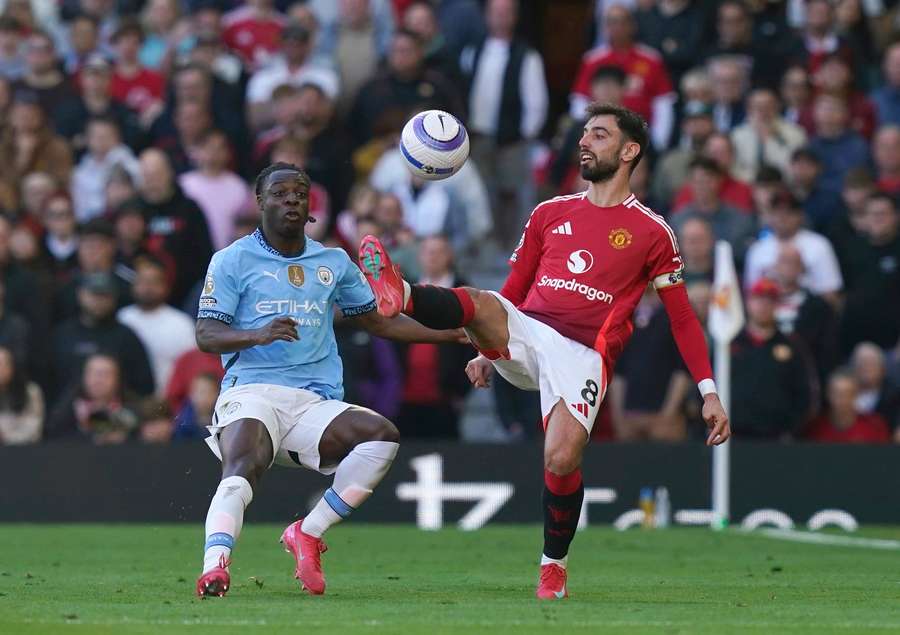 Man City's Jeremy Doku and Man United's Bruno Fernandes during the Manchester derby at Old Trafford on April 6, 2025