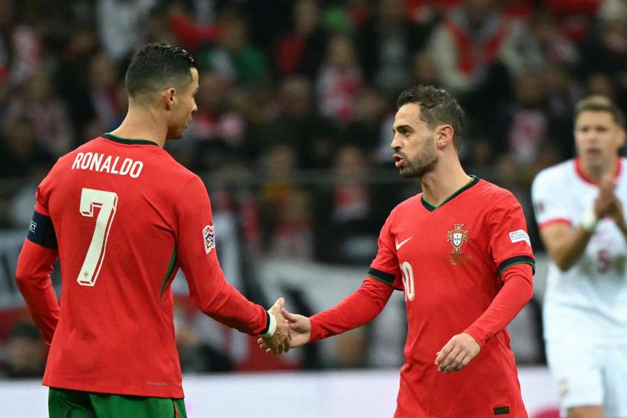 Bernardo Silva celebrates scoring the opening goal with his teammate Cristiano Ronaldo 