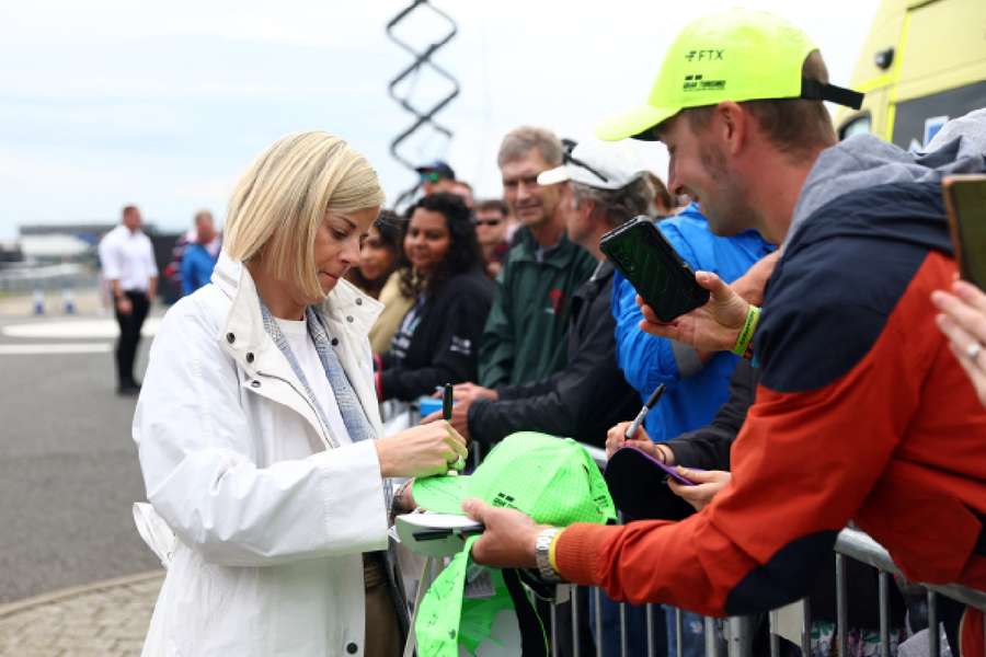 Former racing driver Susie Wolff signs her autograph for fans