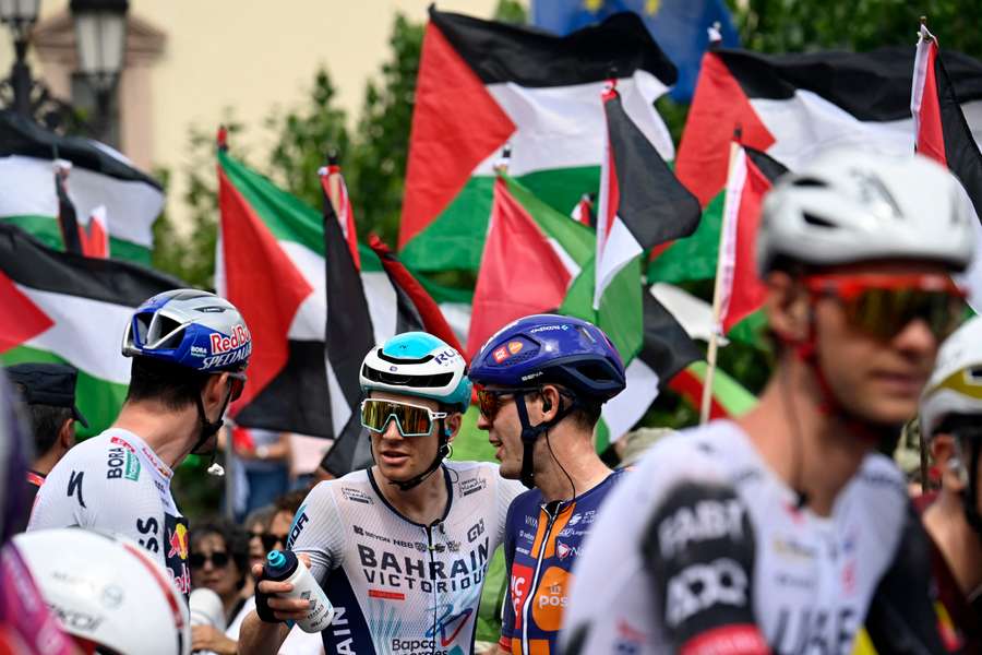 Pro-Palestinian protesters wave flags as riders await the start of the 15th stage of the Vuelta a Espana last Sunday