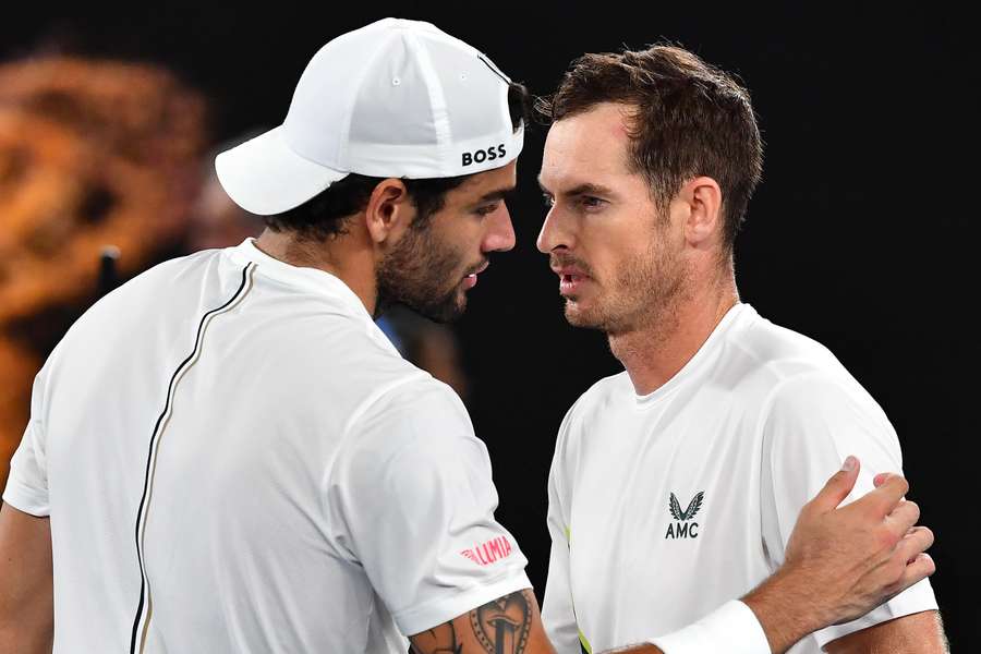 Murray (R) speaks with Berrettini after their match