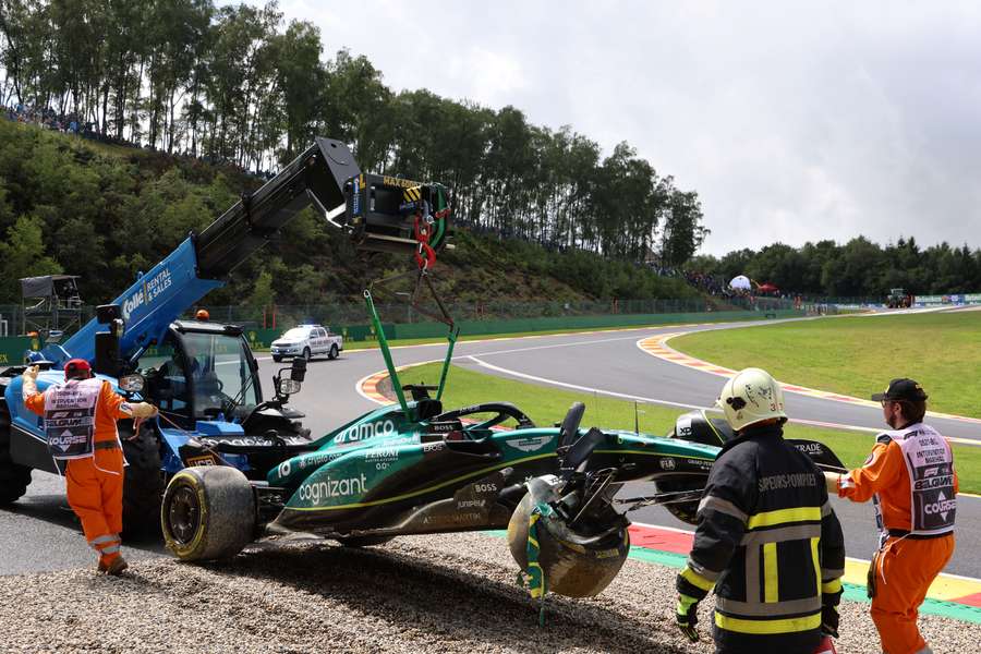 Race marshals remove the car of Aston Martin's Lance Stroll after he crashed during the sprint shootout