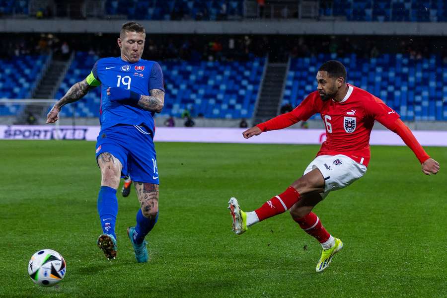 Slovakia's midfielder Juraj Kucka and Austria's defender Philipp Mwene vie for the ball during the friendly