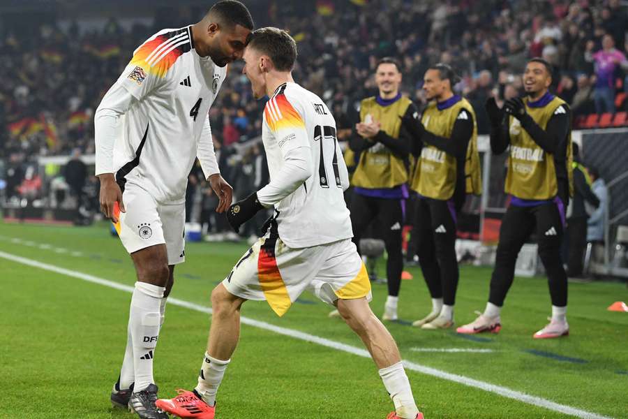 Florian Wirtz celebrates with Jonathan Tah scoring his team's fourth goal during the UEFA Nations League 