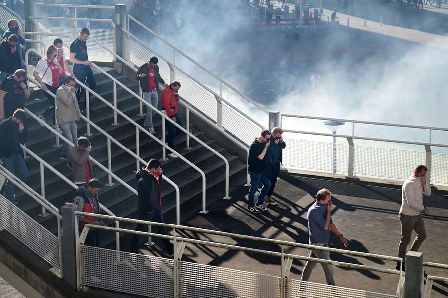 Visitors of Ajax - Feyenoord have to leave the ArenA through a cloud of smoke and tear gas