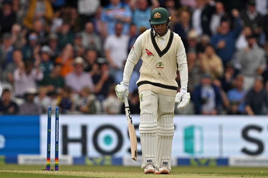 Australia's Usman Khawaja reacts as he walks back to the pavilion after losing his wicket for 13 runs