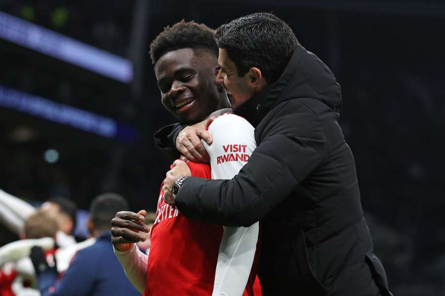 Bukayo Saka (L) and Mikel Arteta celebrate Arsenal's win against Spurs