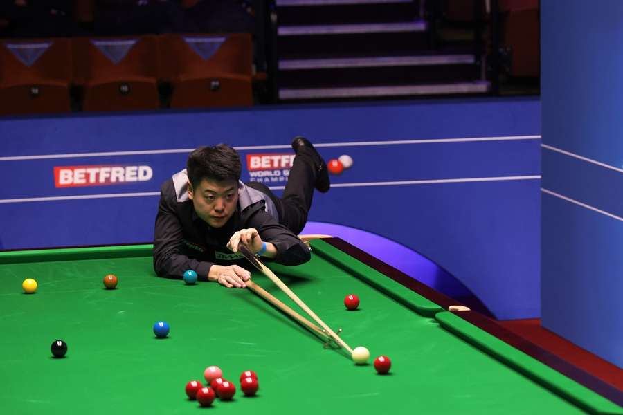 Liang Wenbo of China plays a shot during day 2 of the Betfred World Snooker Championships 2021 at The Crucible