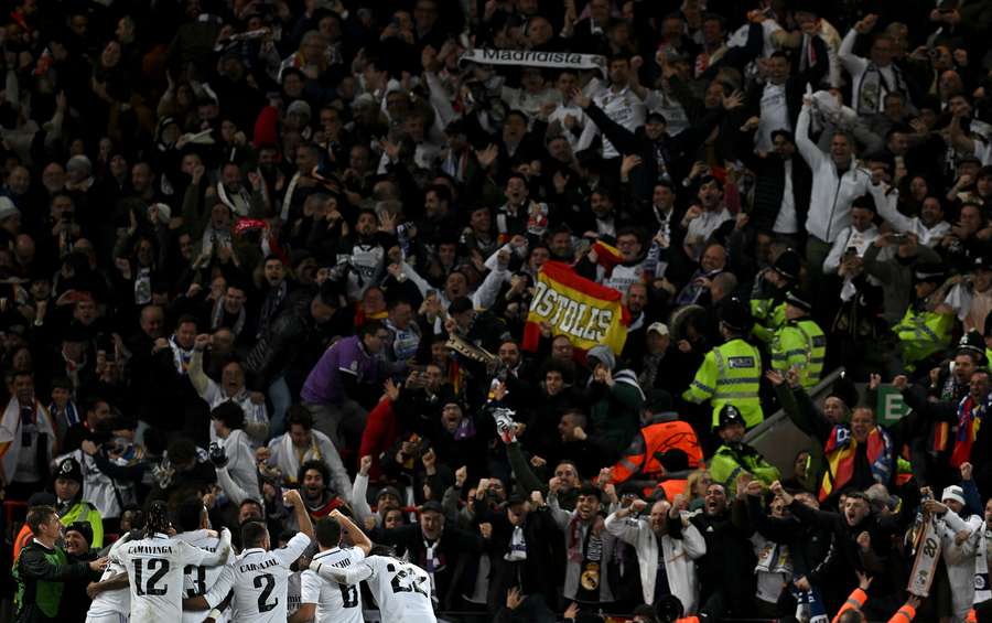 Real Madrid players celebrate in front of jubilant fans after their fifth goal