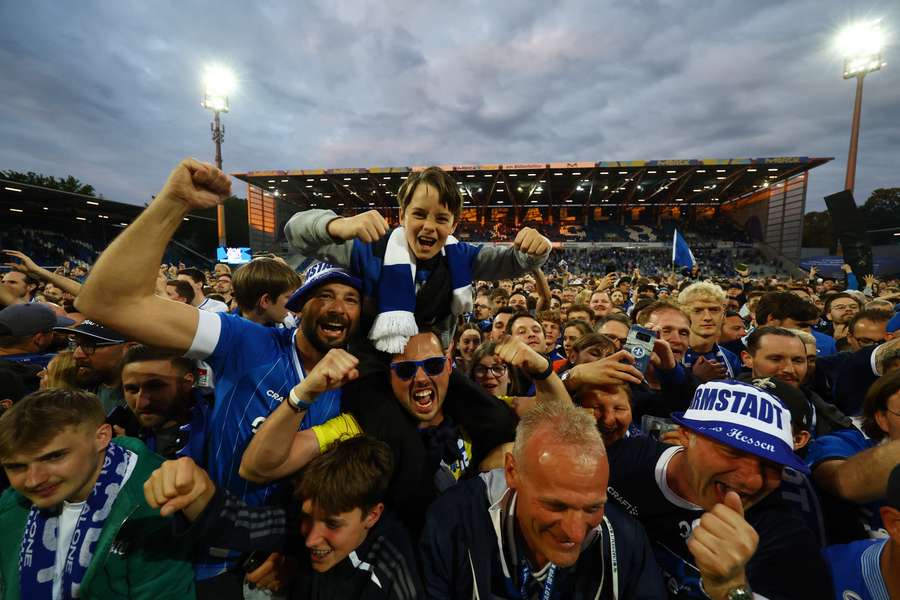 Darmstadt's fans celebrate on the pitch