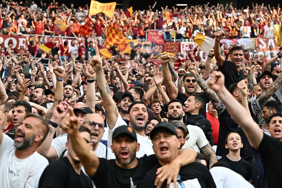 Roma fans cheer ahead of the match