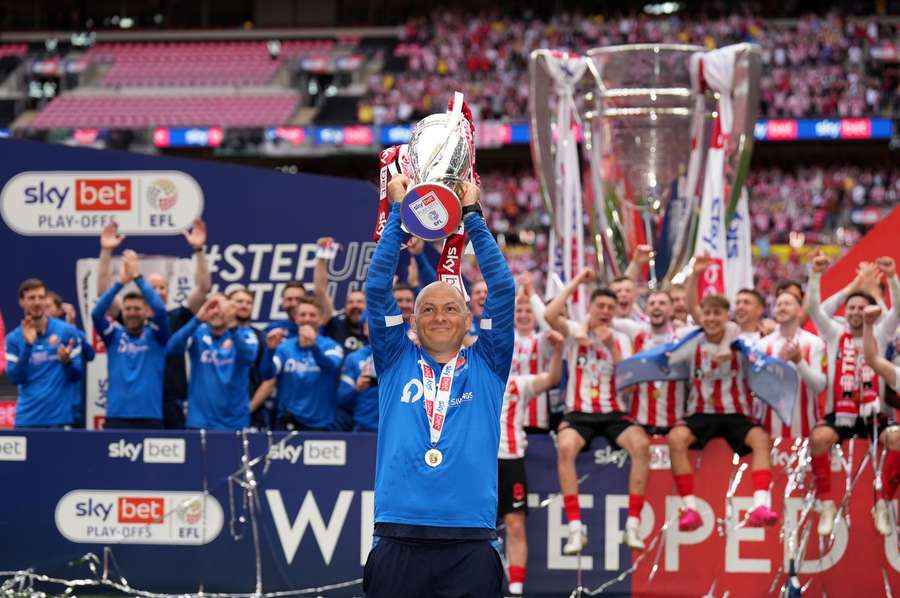 Sunderland manager Alex Neil celebrates with the trophy after the League One playoff final in 2022 Sunderland manager Alex Neil celebrates with the trophy after the League One playoff final in 2022