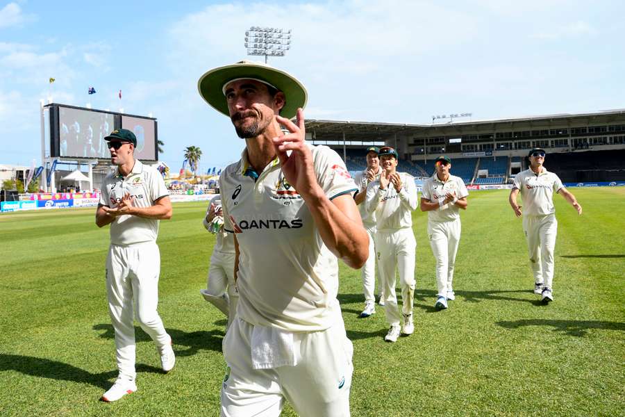 Mitchell Starc of Australia walks off the field waving to supporters during the third day of the third Test between West Indies and Australia