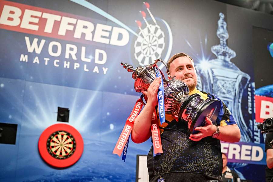 Luke Littler poses with the Phil Taylor trophy Luke Littler poses with the Phil Taylor trophy