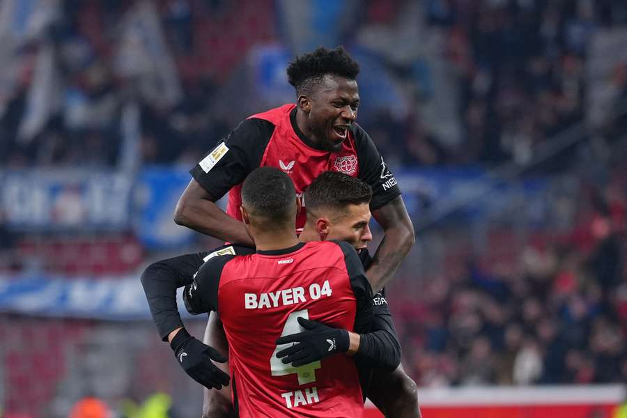 Bayer Leverkusen's Patrik Schick is celebrated by teammates Jonathan Tah and Edmond Tapsoba after scoring against Hoffenheim