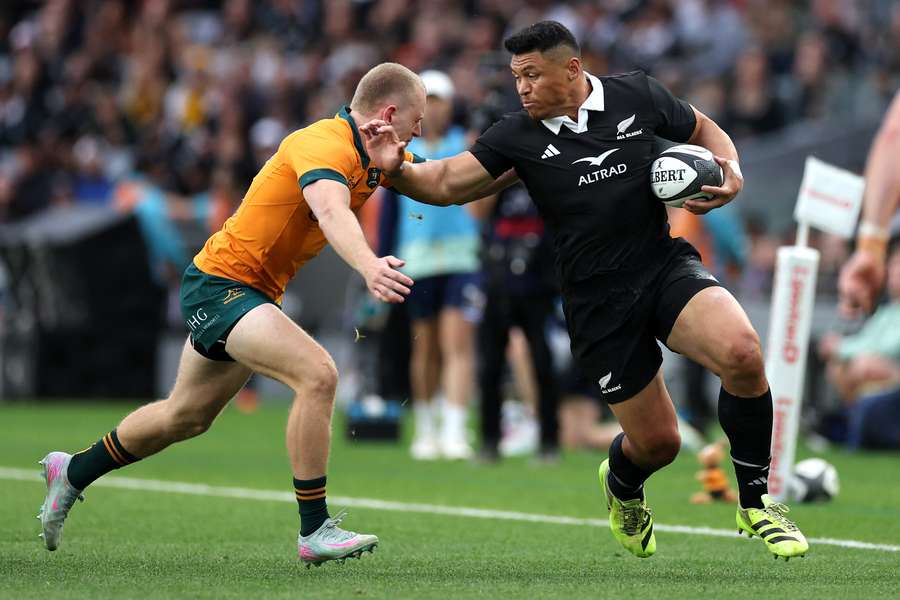All Blacks winger Caleb Clarke fends off a would-be tackler against Australia earlier this year.