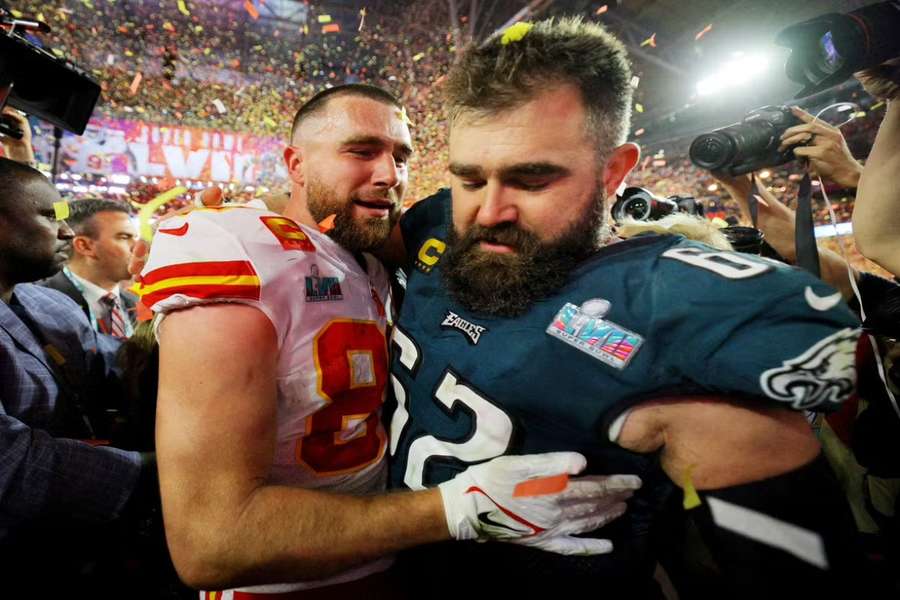 Travis Kelce (L) consoles his brother Jason after the Super Bowl