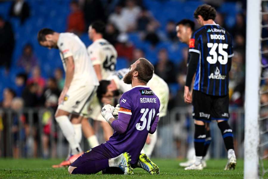 Central Coast Mariners goalkeeper Andrew Redmayne celebrates their clean sheet victory over Auckland.
