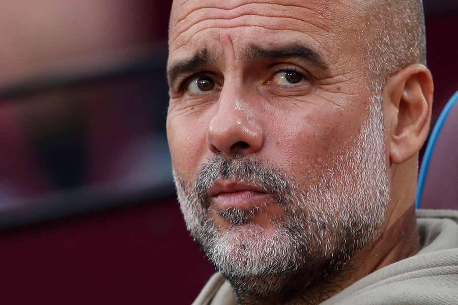 Pep Guardiola looks on ahead of kick-off in the English Premier League football match between West Ham United and Man City