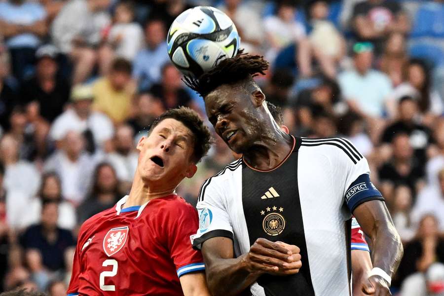 Germany's Yann Bisseck (R) and the Czech Republic's Martin Vitik fight for the ball