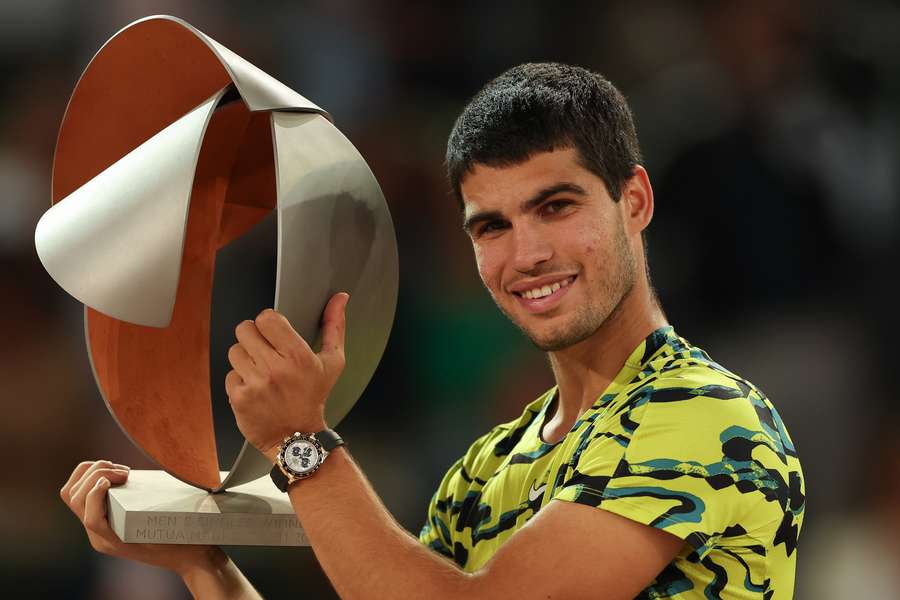 Spain's Carlos Alcaraz poses for pictures with the trophy after winning the 2023 ATP Tour Madrid Open tennis tournament singles final