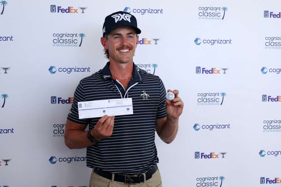 Knapp poses with his scorecard and ball after his impressive round