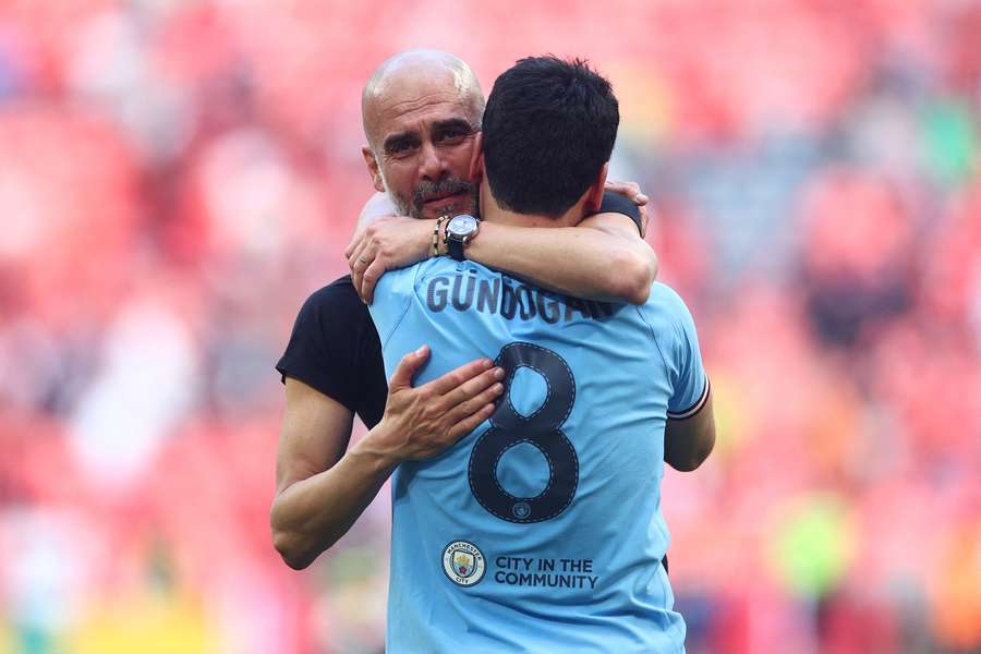 Manchester City manager Pep Guardiola and Ilkay Gundogan celebrate after winning the FA Cup in 2023