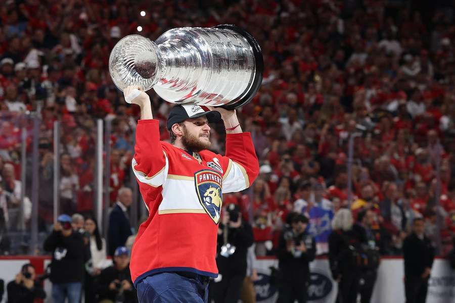 Barkov  holds the Stanley Cup aloft last season