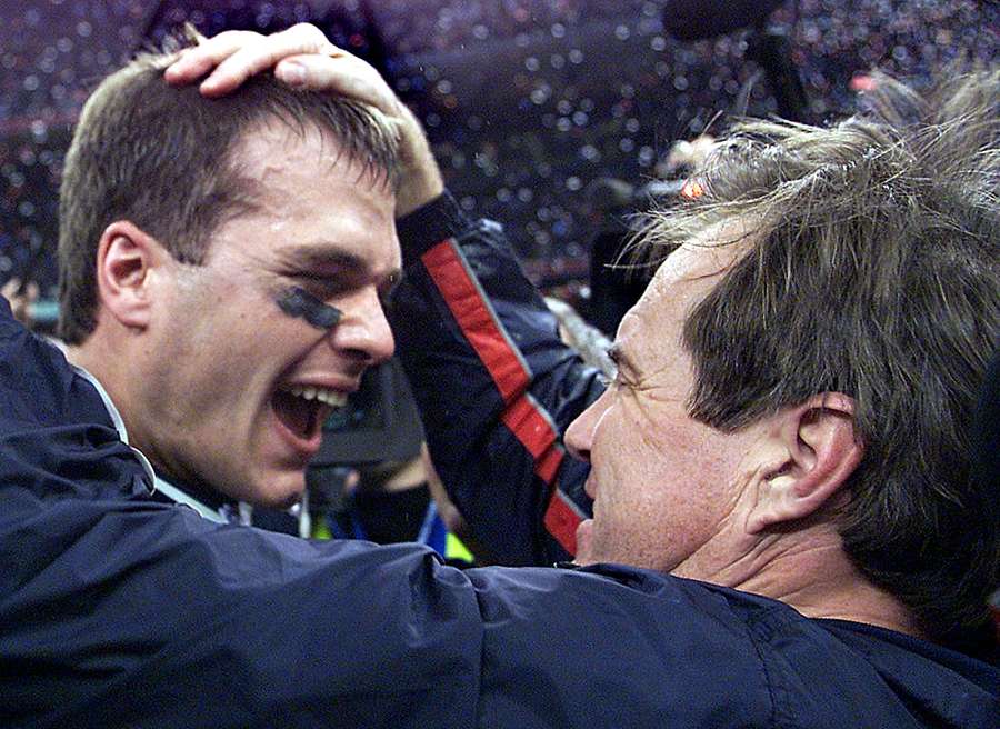 In this file photo taken on February 02, 2002, New England Patriots' quarterback Tom Brady celebrates with head coach Bill Belichick (R) after their win over the St. Louis Rams in Super Bowl XXXVI