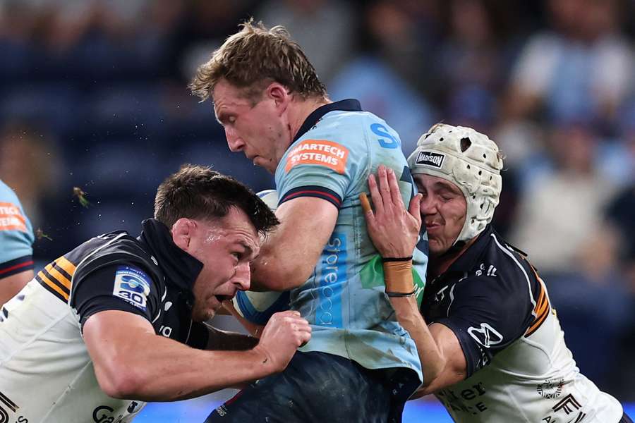 Waratahs winger Harry Potter gets crushed by two Brumbies opponents on Friday night. Waratahs winger Harry Potter gets crushed by two Brumbies opponents on Friday night.