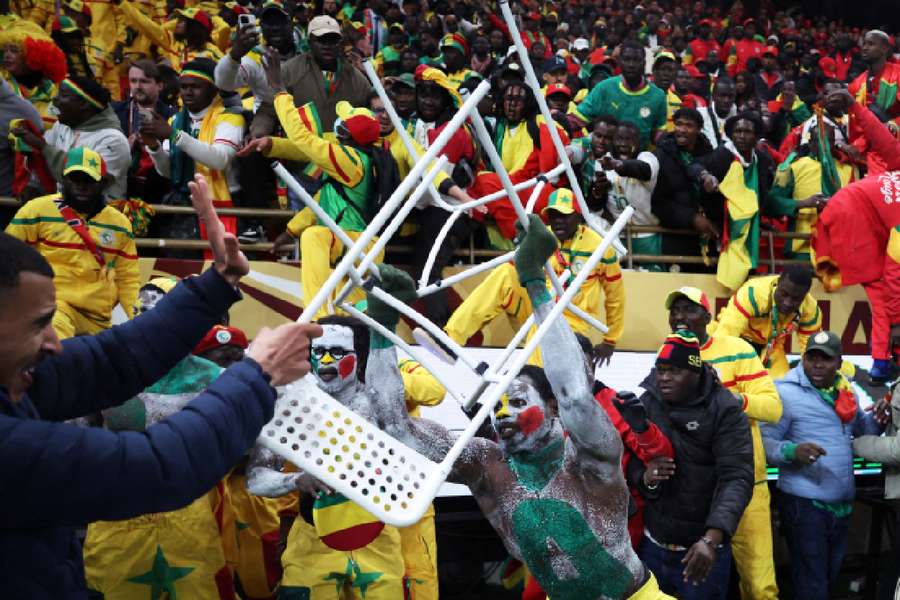 Senegal fan clashes with security as fans invade the pitch after Morocco were awarded a penalty