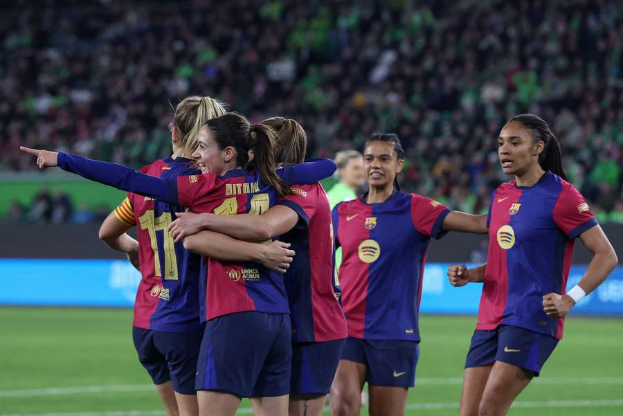 Barcelona players including Spanish midfielder Aitana Bonmati celebrate the opening goal against Wolfsburg