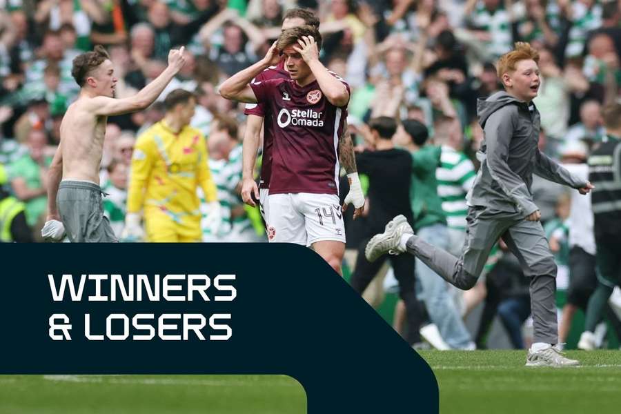 Heart of Midlothian players are seen at full-time as Celtic fans invade the pitch after the title was won in Scotland