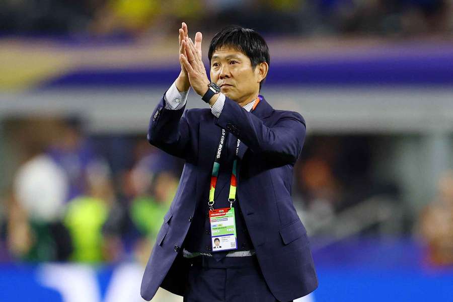 Japan head coach Hajime Moriyasu applauds fans