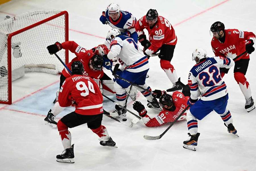 Players vie for the puck in front of Canada's goal during the quarter-final clash Players vie for the puck in front of Canada's goal during the quarter-final clash