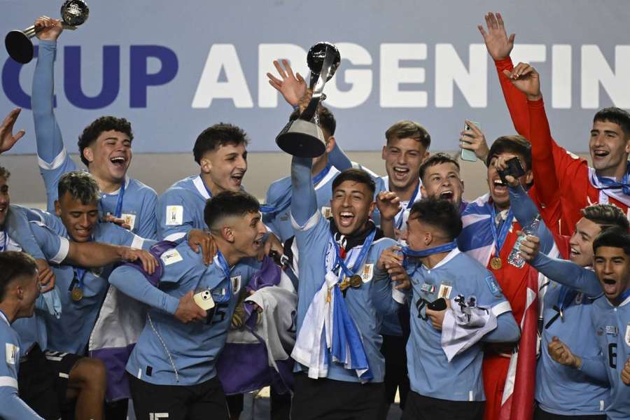 Uruguay captain Fabricio Diaz holds the trophy aloft as the team celebrate their U20 World Cup win