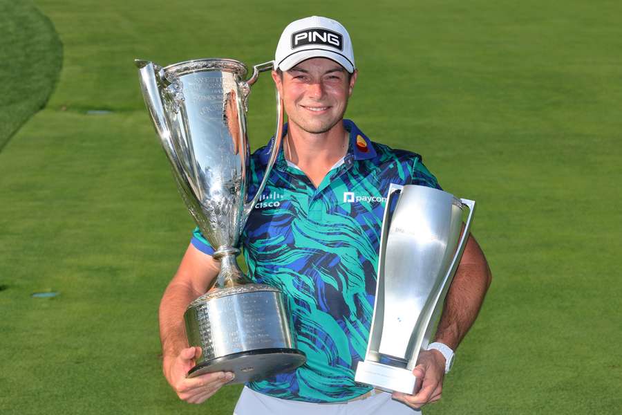 Viktor Hovland of Norway poses with The Western Golf Association Trophy and BMW Trophy