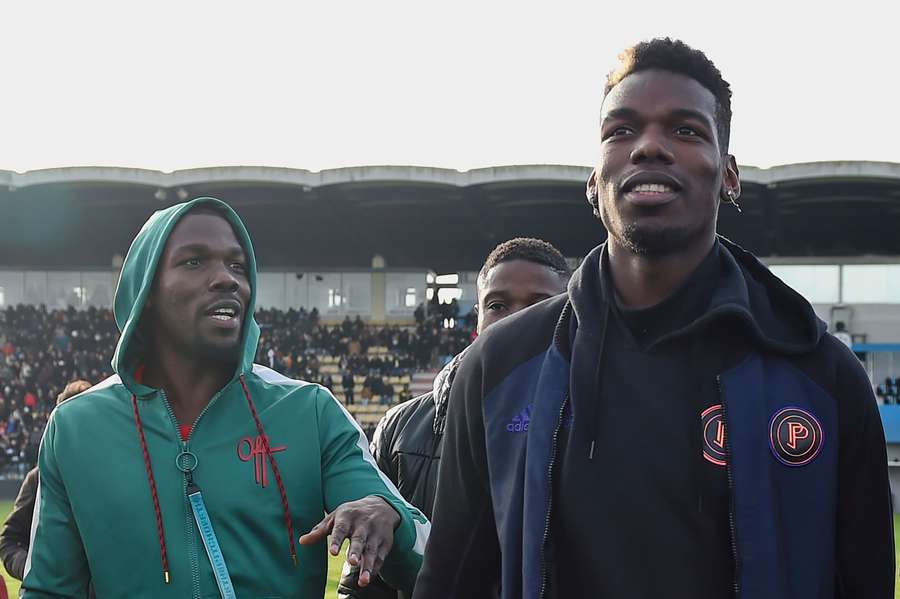 French player Paul Pogba (R) and his brother Mathias Pogba (L) on the pitch prior to match between All Star France and Guinea in 2019