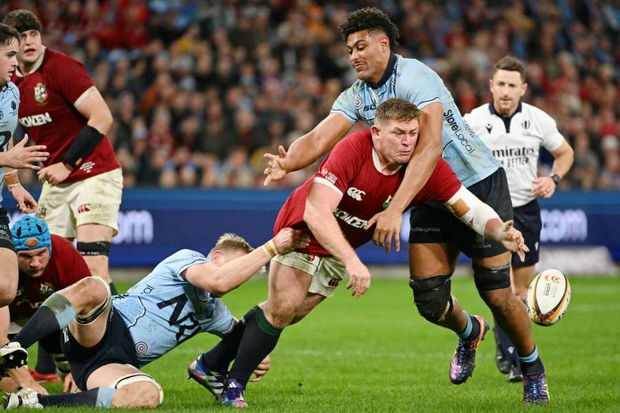 Waratahs' Miles Amatosero lays a crunching tackle on British & Irish Lion Tadhg Furlong.