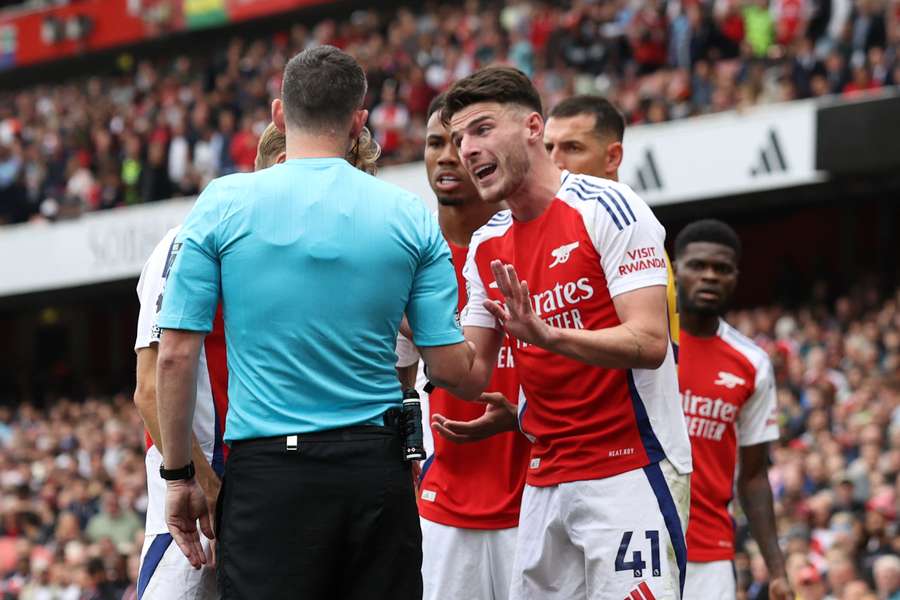 Arsenal's Declan Rice interacts with referee Chris Kavanagh after being shown a second yellow card