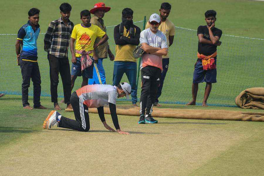 India captain Shubman Gill and coach Gautam Gambhir (standing) inspect the Eden Gardens pitch. India captain Shubman Gill and coach Gautam Gambhir (standing) inspect the Eden Gardens pitch.