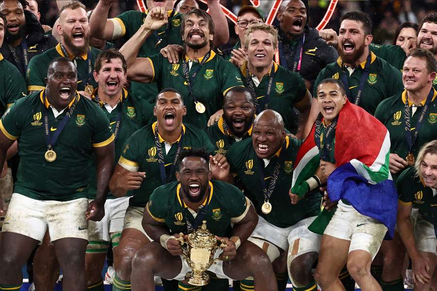 South Africa's flanker and captain Siya Kolisi prepares to lift the Webb Ellis Cup after beating New Zealand in the Rugby World Cup final