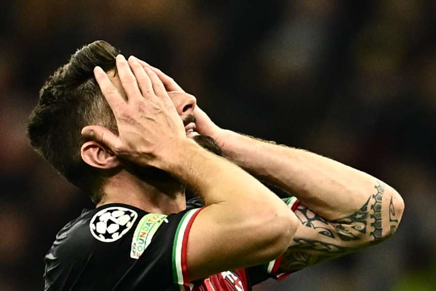 AC Milan's Olivier Giroud reacts after missing an opportunity to score