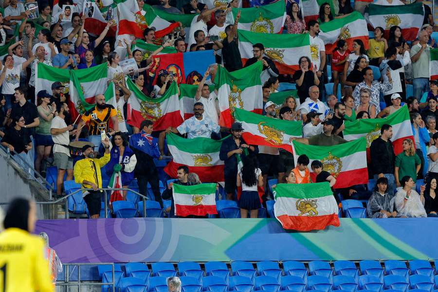 Iranian supporters wave Pahlavi-era flags during the Women's Asian Cup.