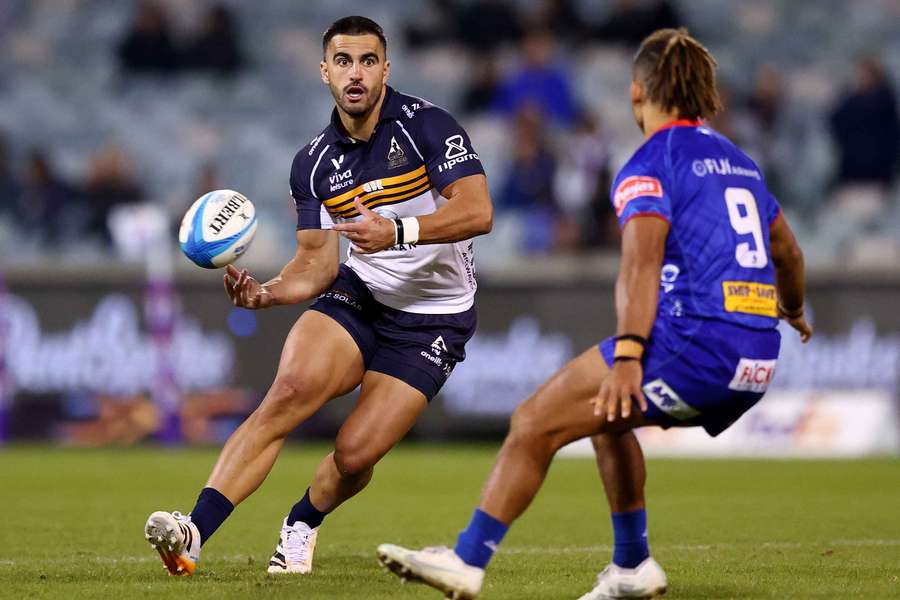 Tom Wright flicks the ball off in last weekend's loss to the Fijian Drua.