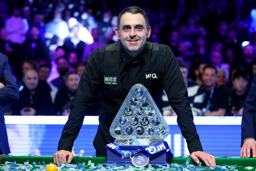 Ronnie O'Sullivan poses with the trophy after winning the MrQ Masters Final against Ali Carter 