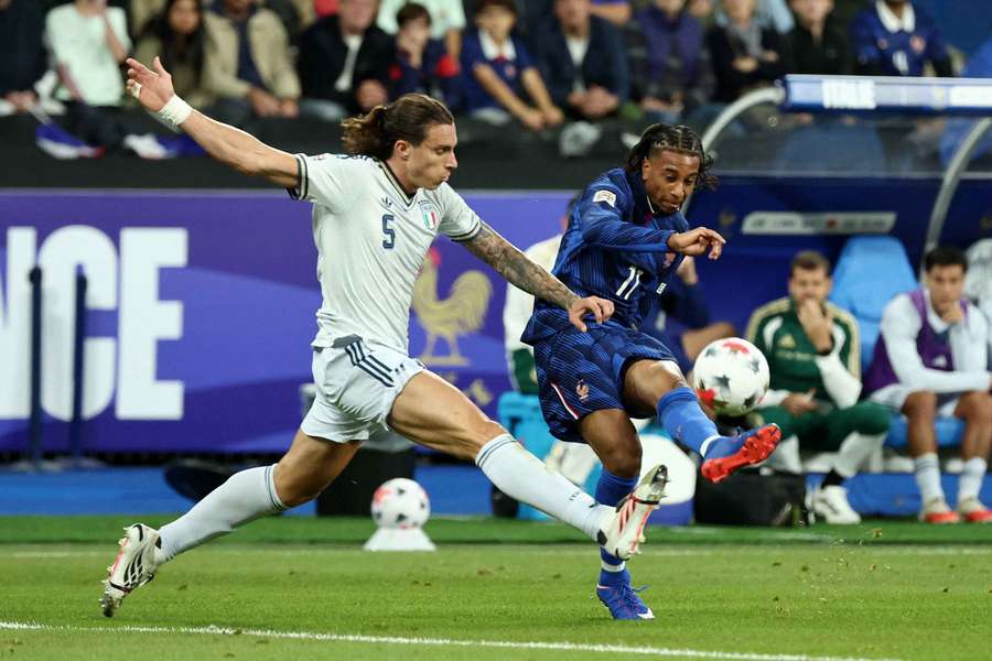 Italy's Riccardo Calafiori in action with France's Michael Olise 